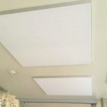 White Acoustic Panels Fitted Directly Onto The Ceiling In A Hotel Foyer