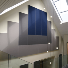 multiple acoustic panels arranged on club house wall to control reverberation